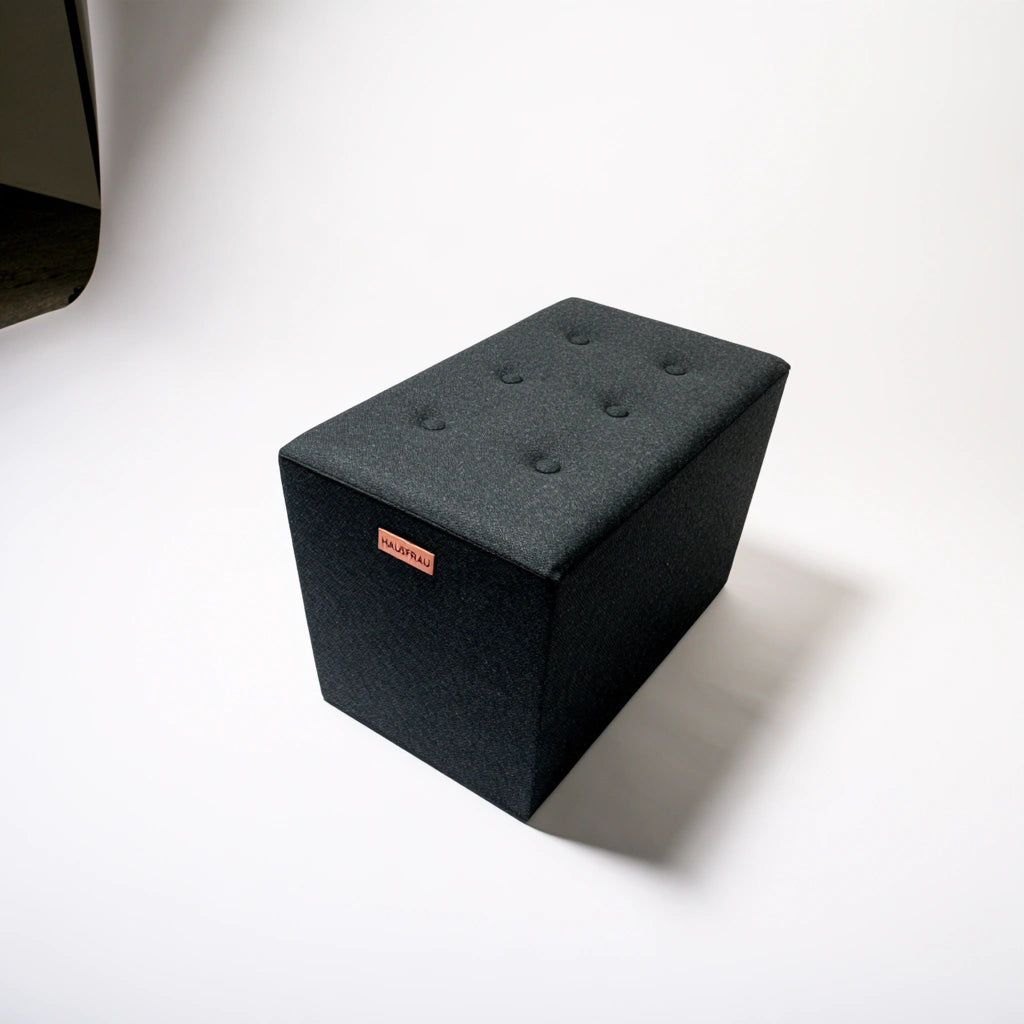 Dark grey rectangular storage bench with tufted lid, suitable for living room furniture by PedestalDiningCo.